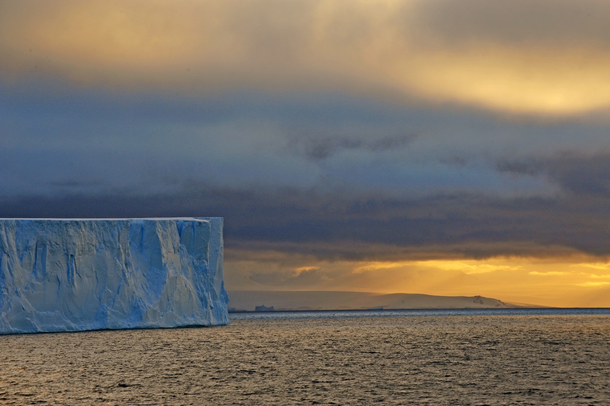 Elsewhere tabular bergs stand majestically tall as the last minutes of daylight shimmer in the horizon.