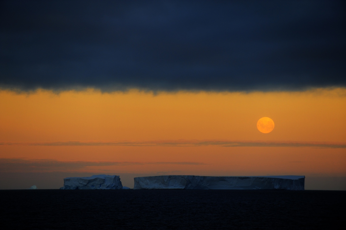 A full moon above tabular bergs on Christmas Day - a once in 75 year phenomenon.